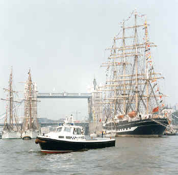 duty boat with tall ships