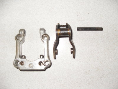 at the bottom of the U shaped bracket are 2 plungers. I bet your's are stiff/stuck?